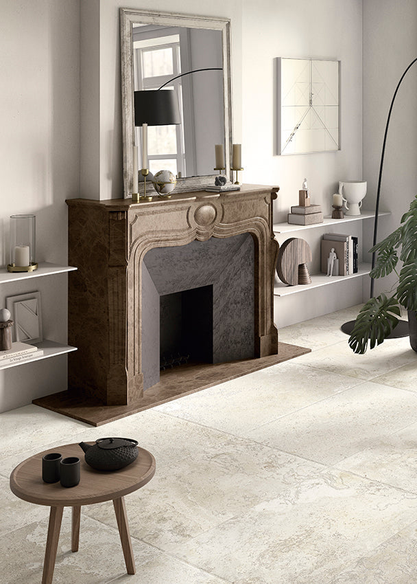 Living room with a fireplace, chair, and rustic tiles. 