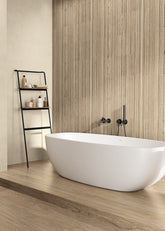 Modern bathroom with a freestanding bathtub, sink, and shelves.