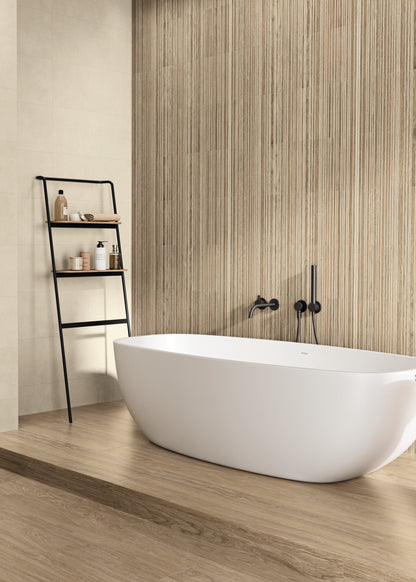 Modern bathroom with a freestanding bathtub, sink, and shelves.