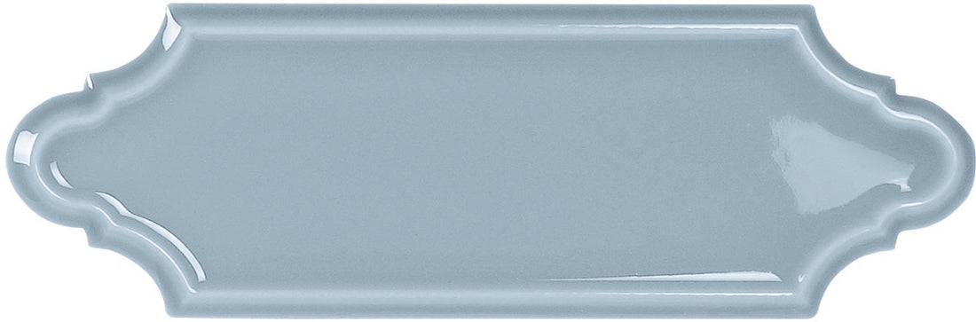 Light blue decorative tile with scalloped edge on a white background