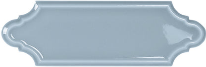 Light blue decorative tile with scalloped edge on a white background